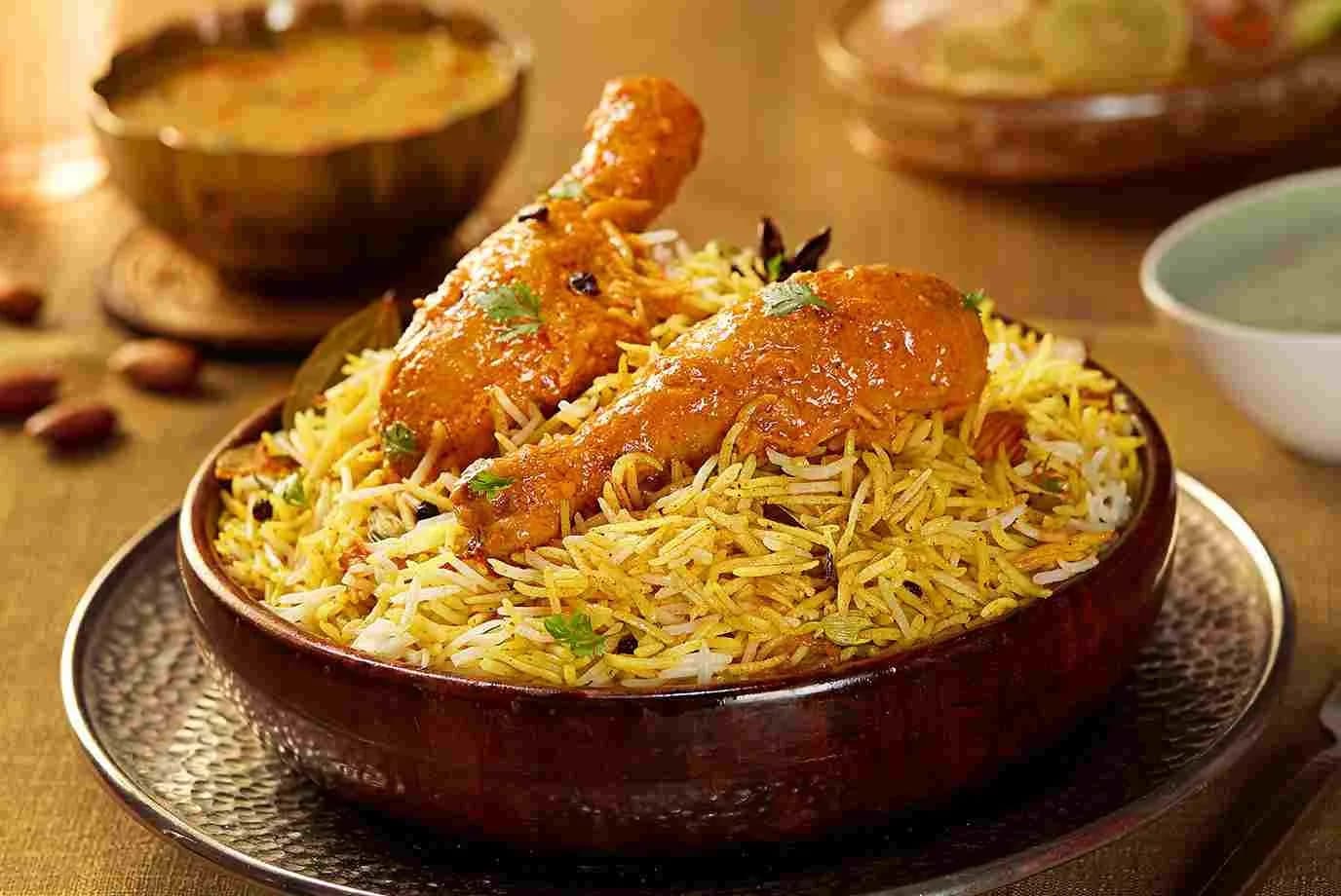Chicken biryani served on a hammered brass platter